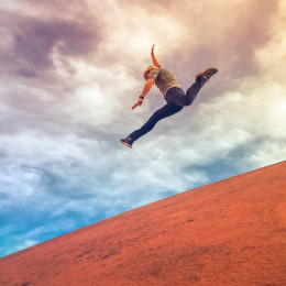 Man Jumping Down A Hill