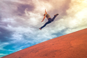 Man Jumping Down A Hill
